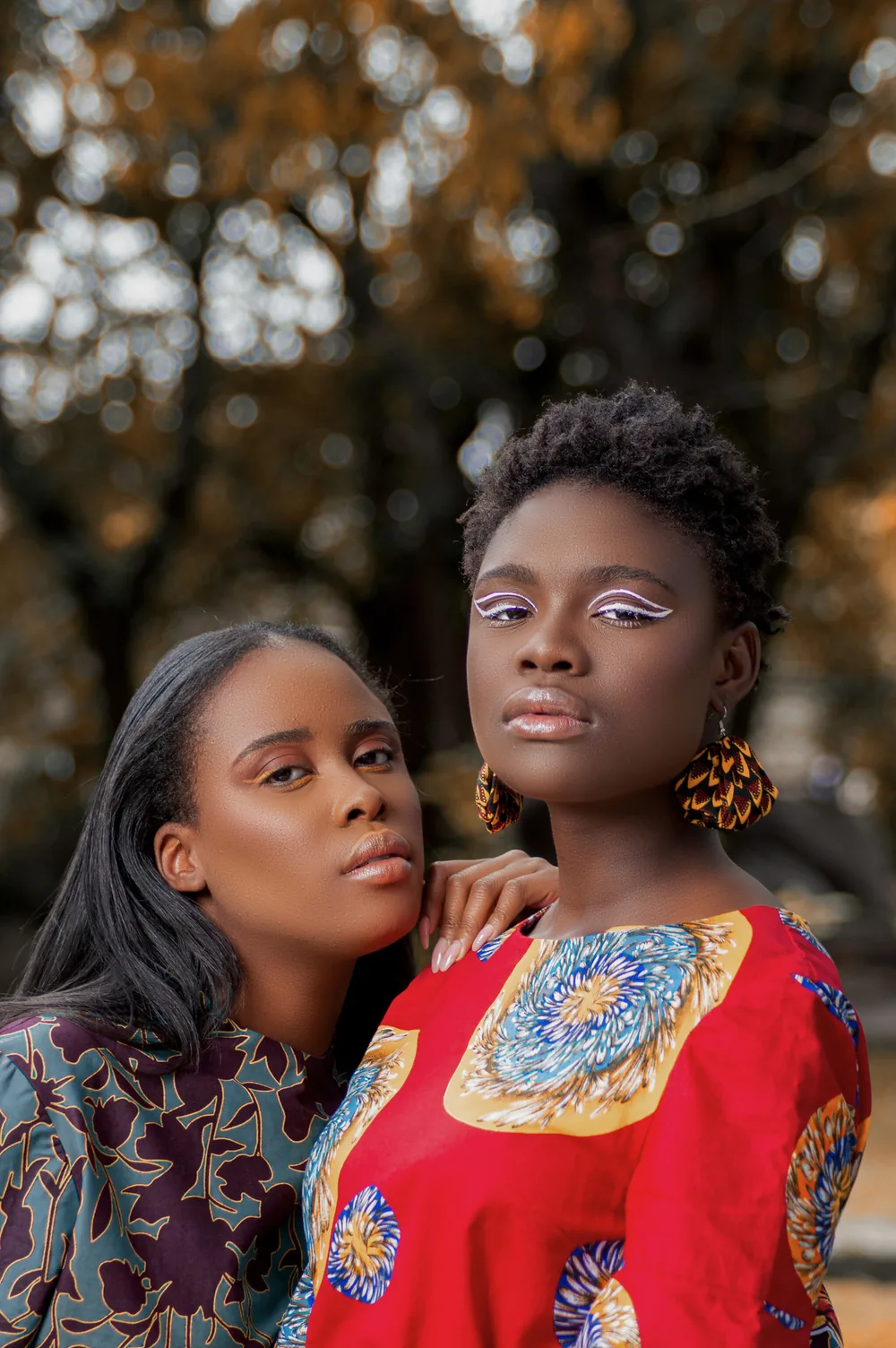 Two women wearing African print garments
